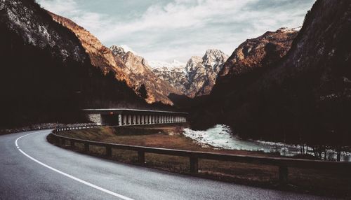 Road by mountain against sky