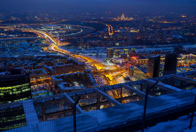 High angle view of illuminated cityscape against sky at night
