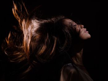 Close-up of hair over black background