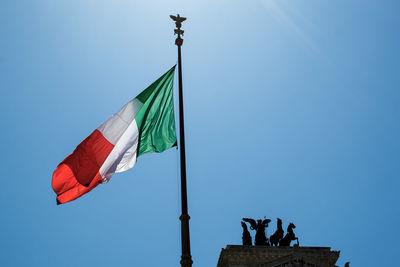 Low angle view of italian flag against clear blue sky