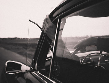 Close-up of man hand at car window