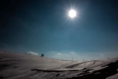 Scenic view of landscape against sky during winter