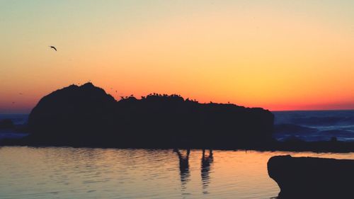 Scenic view of sea against clear sky at sunset