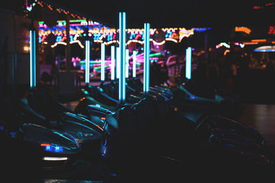 Illuminated carousel in amusement park at night