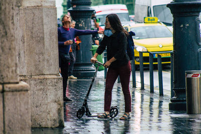 People on sidewalk in city