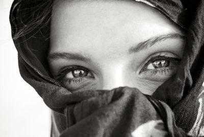 Portrait of woman face covered with scarf