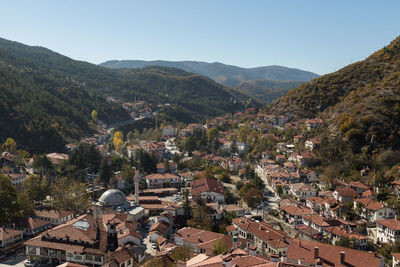 High angle view of trees and mountains against clear sky