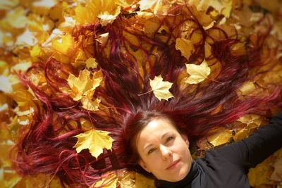 Portrait of woman with red leaves