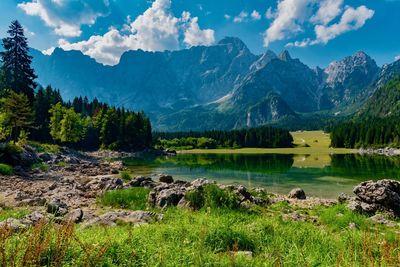 Scenic view of lake and mountains against sky