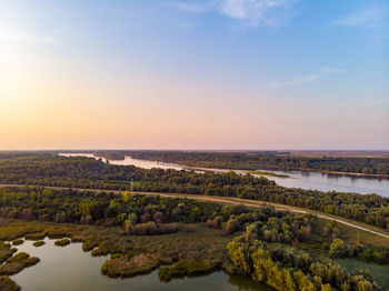 Scenic view of lake against sky during sunset