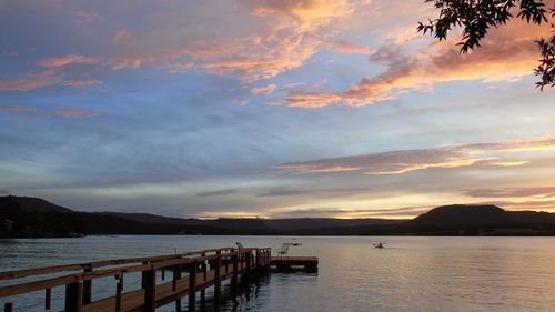 Scenic view of lake against sky at sunset