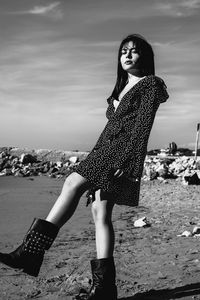 Full length portrait of woman standing on beach