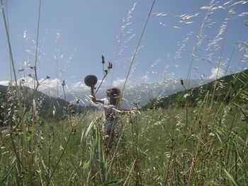 Panoramic shot of grass on field against sky