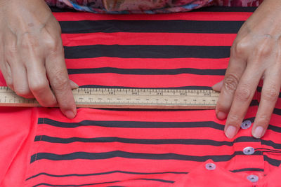 Midsection of tailor measuring textile