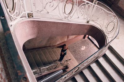 High angle portrait of woman standing on steps