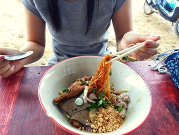 Midsection of man eating food