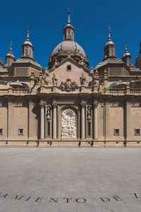 Facade of historic building against clear sky