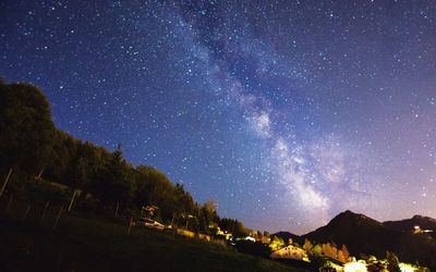 Scenic view of mountains against star field