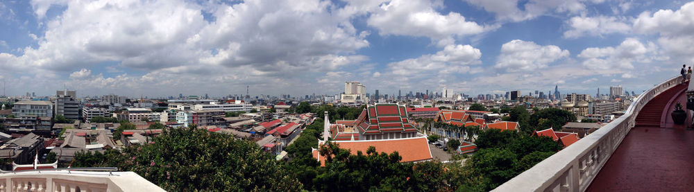 Cityscape against cloudy sky