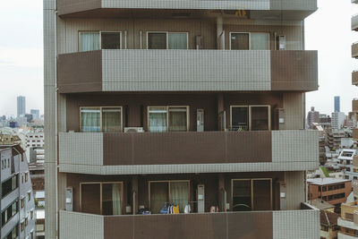 View over houses in tokyo, japan. low angle view of skyscrapers against sky