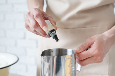 Midsection of man holding coffee