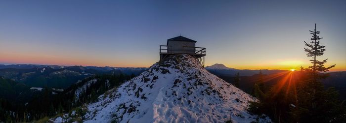 Scenic view of snowcapped mountains against sky during sunset