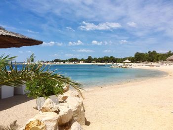 View of beach against cloudy sky