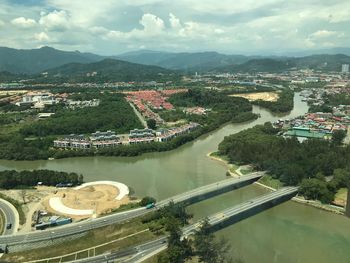 High angle view of river amidst city against sky