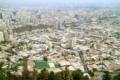 High angle view of buildings and trees in city