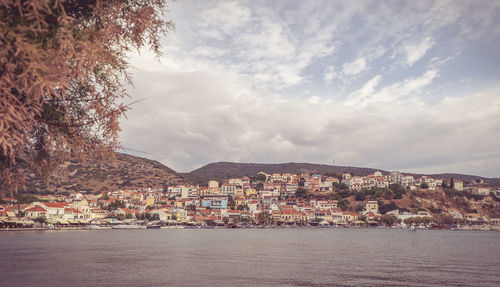 Town by sea against sky in city