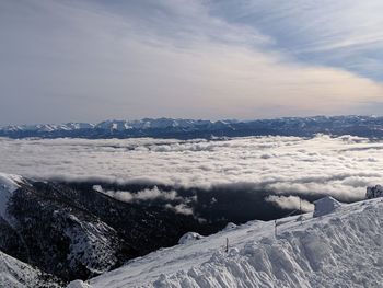 Scenic view of snow covered mountains against sky