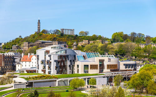 Buildings against clear blue sky