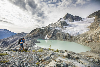 Backpacker hiking with view of lake and mountains