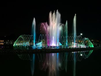 Panoramic view of illuminated city against sky at night