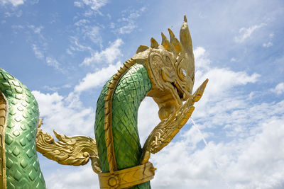 Low angle view of angel statue against sky