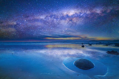 Scenic view of landscape against sky at night