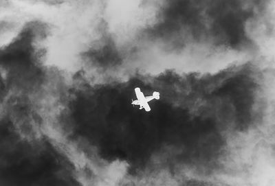 Low angle view of airplane flying in sky