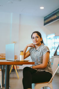 Young woman using laptop at home