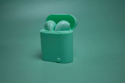 High angle view of blue plastic container on green background