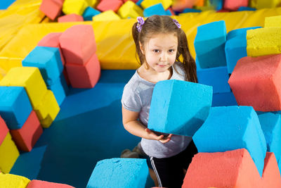 Portrait of a girl with colorful toys