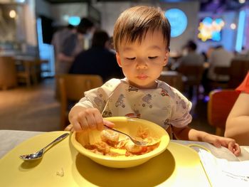 Portrait of boy eating food