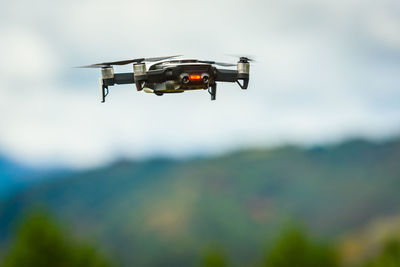 Low angle view of helicopter flying against sky