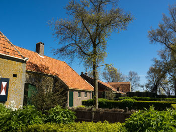 Low angle view of buildings against clear blue sky