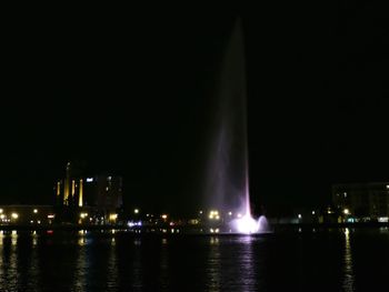 Illuminated city at waterfront