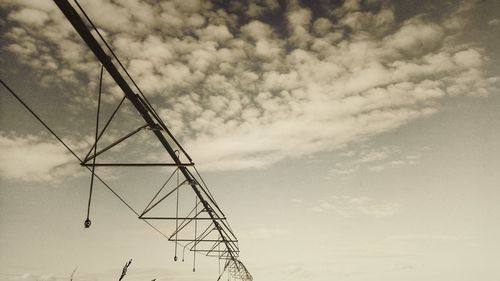 Low angle view of electricity pylon against sky