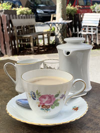 Close-up of a coffee cup on table and seatings in the background 