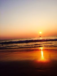 View of calm beach at sunset