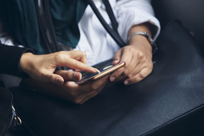 Midsection of man using mobile phone