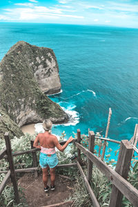 High angle view of woman looking at sea