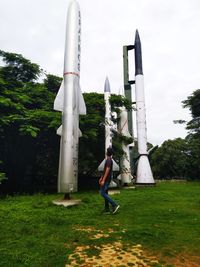 Full length of man standing spaceship against trees